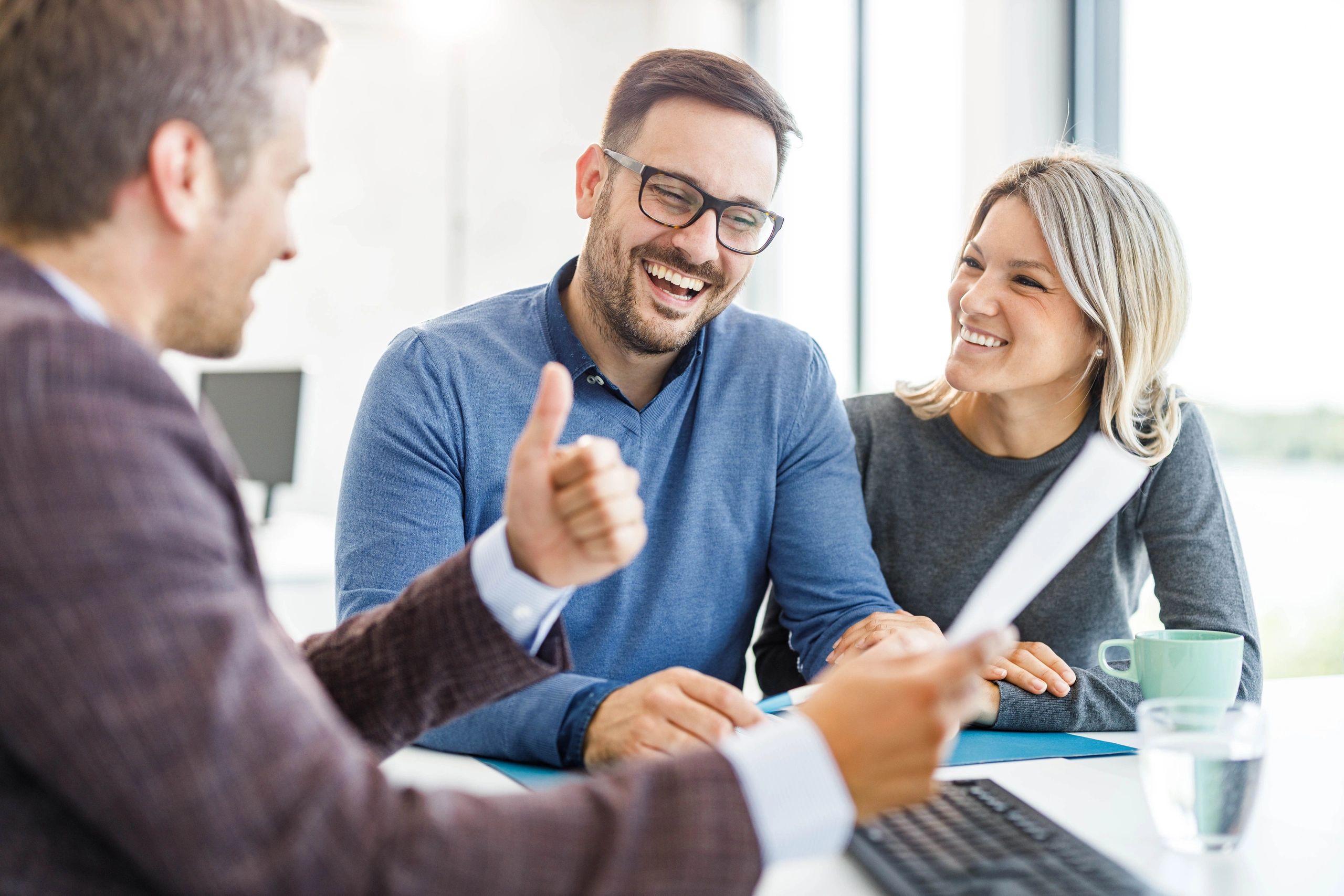 Agent meeting with clients to review plans